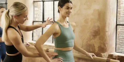 Barrecore, a barre brand under United Fitness. Two women are depicted at barre class.